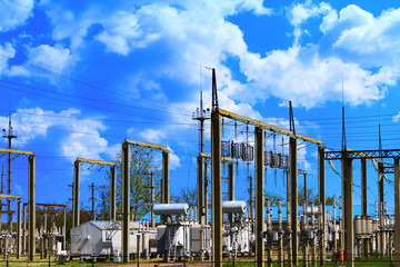 High voltage electric power station - electric poles and lines on very blue cloudy sky background