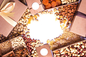 Nuts and dried fruits in the craft package. Photo for the catalog. Place for logo, your text.