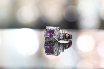 Purple gemstone on diamond ring