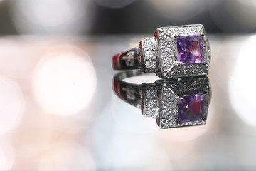 Purple gemstone on diamond ring