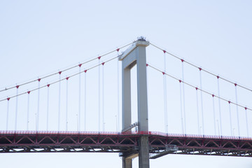 a red metal suspension bridge in sky