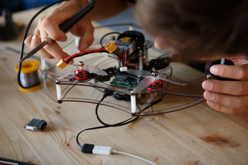 Image of young man with soldering iron chipping mechanism