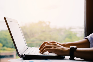 Man working at home office hand on keyboard close up