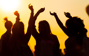 Sunset party dancers silhouettes at summer music festival
