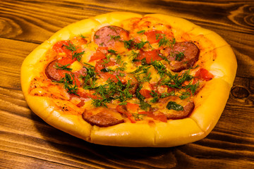 Fresh homemade pizza on a wooden table