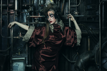 Fototapeta na wymiar Aggressive stylish steampunk lady in a creative interior. Art an fashion concept.