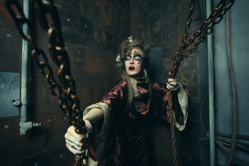 Aggressive stylish steampunk lady in a creative interior.