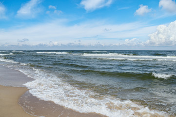 Baltic Sea - water waves. Beautiful blue sky with cumulous clouds and turbulent sea 