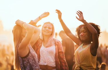 Multiethnic friends celebrating summer holi festival