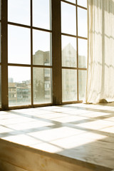 Big wooden window with transparent curtain in sun light