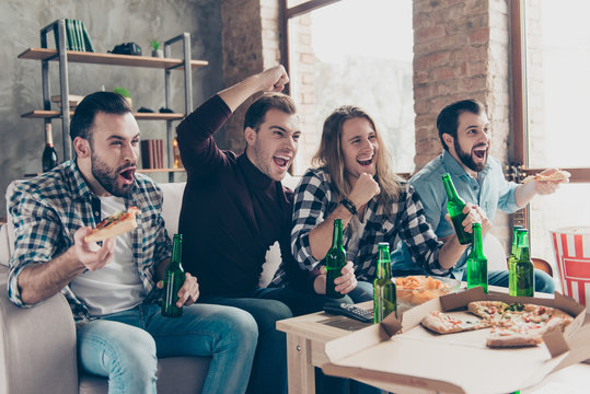 Four stylish, successful, attractive guys in casual outfits, modern hairstyle, raised arms, cheer for favorite team, watching football match, yelling, drinking lager eating snacks, chips, pizza