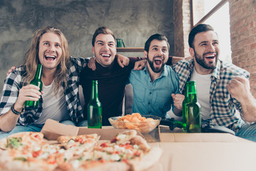 Four stylish, successful, attractive, bearded, joyful guys with modern hairstyle, raised fist, cheer for favorite team, watching, enjoying football match, yelling, drinking lager eating chips, pizza