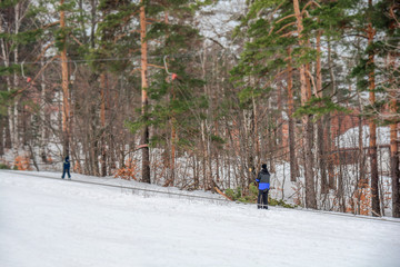 Skier on lift ski cable on snow mountain going up to the top