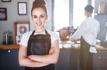 Smiling woman barista in apron, Coffee business owner