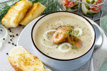 Diet menu. Puree soup mushrooms with croutons in a bowl on a light slate background. The concept of healthy eating.