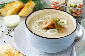 Diet menu. Puree soup mushrooms with croutons in a bowl on a light slate background. The concept of healthy eating.