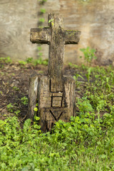 Grave Marker / A wooden grave marker with carved cross and the word love.
