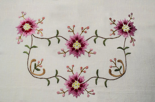 Design for clothes in the style of Boho, embroidered pattern with pinkish-red flower and buds on wavy branches with small leaves