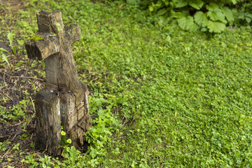 Fototapeta premium Grave Marker / A wooden grave marker with carved cross and the word love.