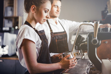 Coffee business, baristas team making coffee using machine at cafe