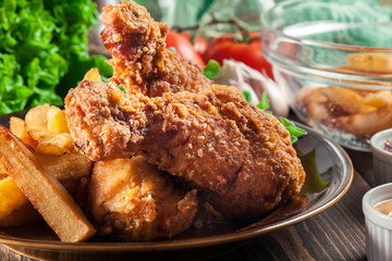 Crispy fried kentucky chicken legs with french fries