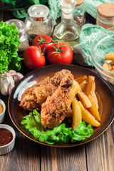 Crispy fried kentucky chicken legs with french fries