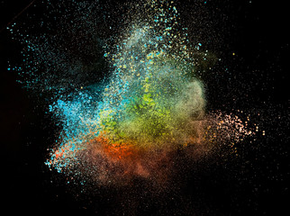 Colored powder explosion isolated on black background.