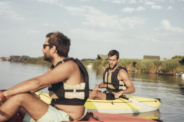 Two Men Kayaking on the River