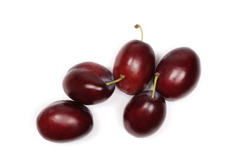 Fresh plums isolated on white background, top view