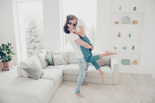 Full size portrait of lovely romantic partners in denim clothes enjoying holiday together in modern living room. Harmony idyllic leisure weekend concept - Powered by Adobe