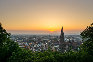 Fototapeta na wymiar Germany, Orange romantic evening mood over Freiburg im Breisgau