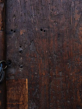 Textured wooden door with metal rivets