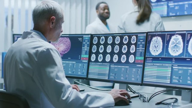  Senior Medical Research Scientist Working with Brain Scans on His Personal Computer. Modern Laboratory Working on Neurophysiology, Science,  Neuropharmacology .Shot on RED EPIC-W 8K.