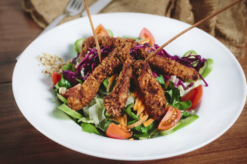 Close-up on a salad with chicken and tomato