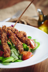 Close-up on a salad with chicken and tomato