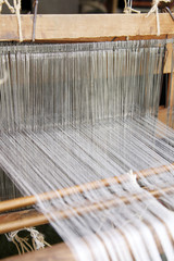 loom with white thread background