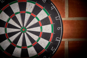 darts on a brick wall