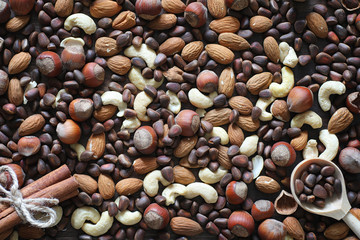 Different nuts on a wooden table. Cedar, cashew, hazelnut, walnu