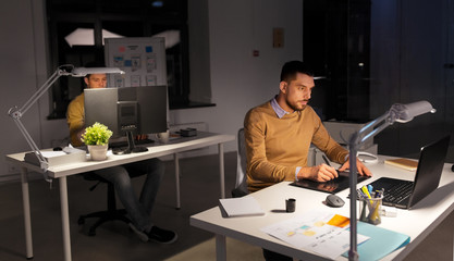 business, technology, design and people concept - young creative man or graphic designer with...