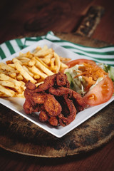 Fried chicken with cajun spices and potatoes