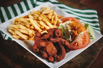 Fried chicken with cajun spices and potatoes