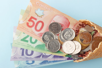 Canadian banknotes on blue background