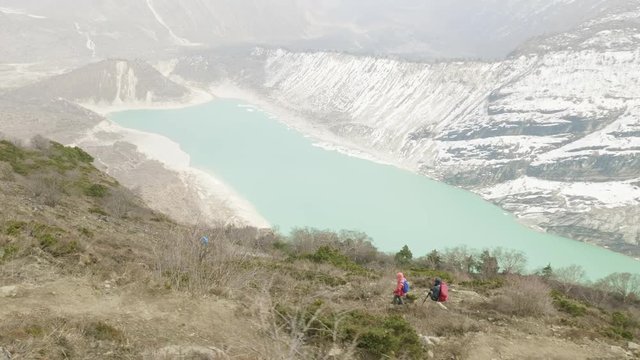 Couple backpackers do acclimatization near lake Birendra in Nepal. Manaslu area.