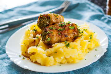 roasted Beef Meat roll stuffed with chicken and pork meat with mashed potatoes in white plate on table