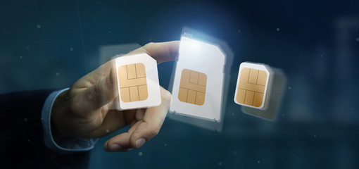 Businessman holding Different size of a smartphone sim card 3d rendering - obrazy, fototapety, plakaty