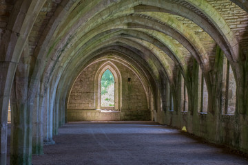 Ancient corridor in monastry with arches