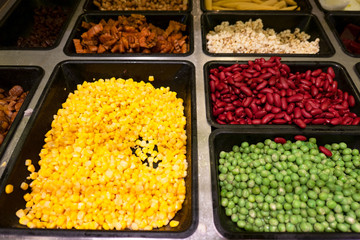 Closeup fresh salad bar with various fresh vegetables in box at supermarket for health .