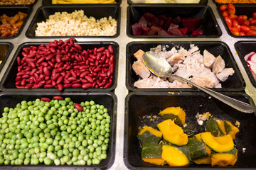 Closeup fresh salad bar with various fresh vegetables in box at supermarket for health .