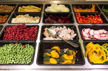 Closeup fresh salad bar with various fresh vegetables in box at supermarket for health .