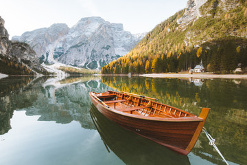 Traditional rowing boat at Lago di Braies at sunrise in fall, South Tyrol, Italy